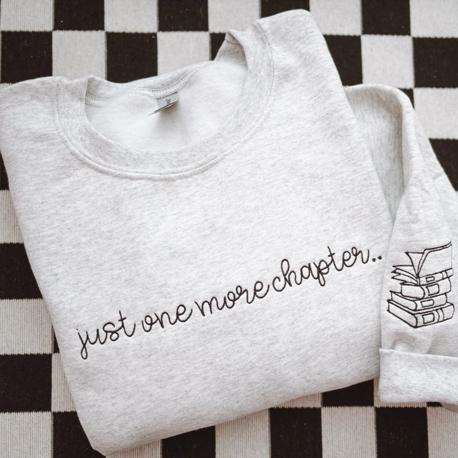 One More Chapter Embroidered Crewneck Sweatshirt – Cozy Book Lover Gift by Graphic tee and co.