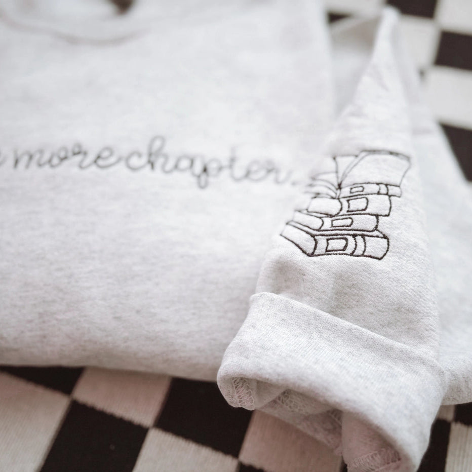One More Chapter Embroidered Crewneck Sweatshirt – Cozy Book Lover Gift by Graphic tee and co.