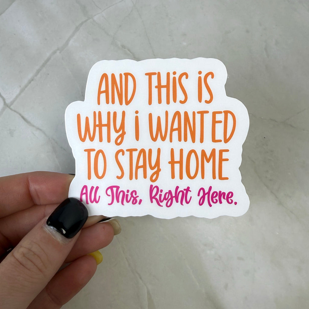 Hand holding a white sticker with text on a light gray background