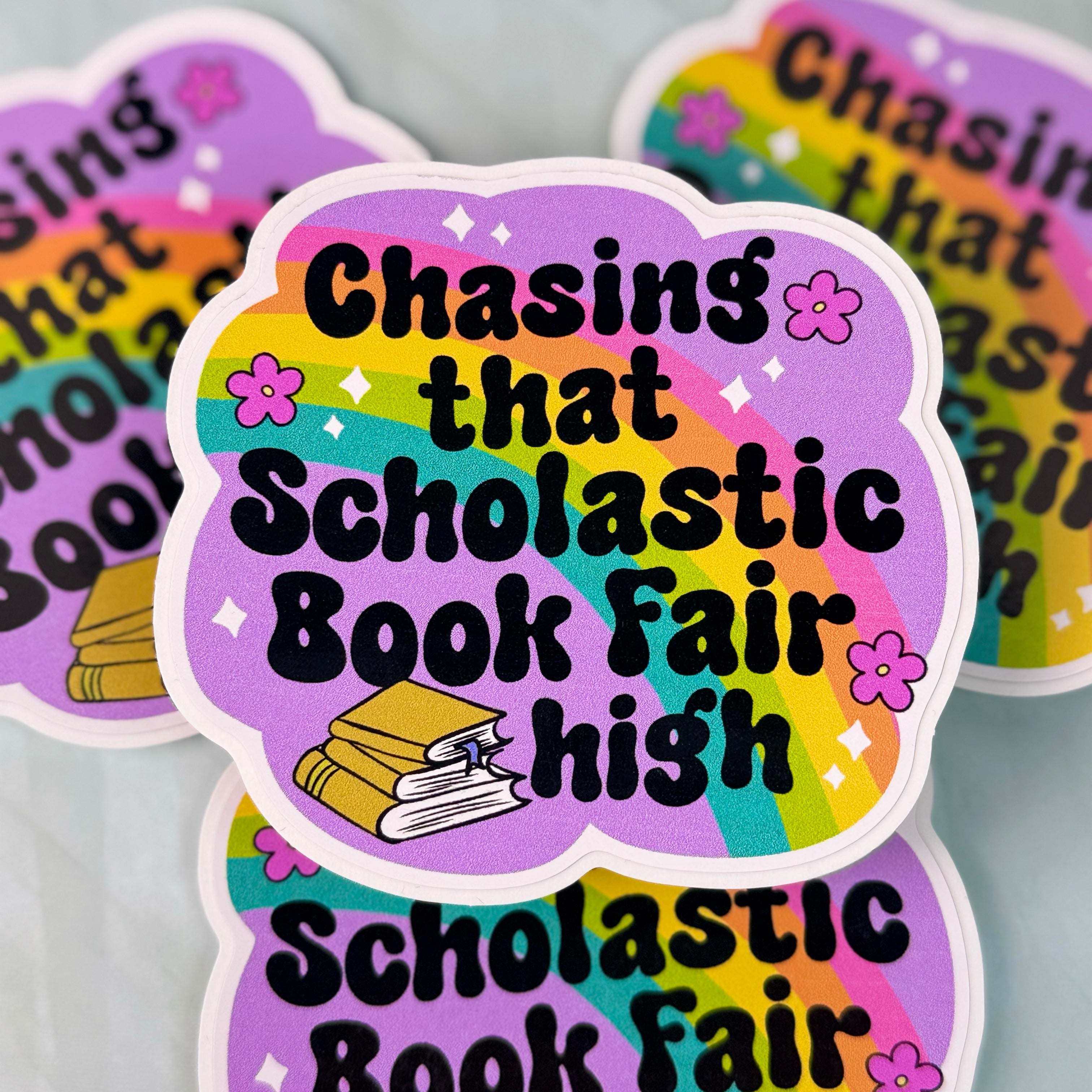 Sticker with 'Chasing that Scholastic Book Fair high' text on a colorful background