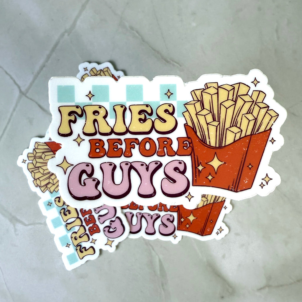 Sticker with 'Fries Before Guys' text and a graphic of fries on a textured surface