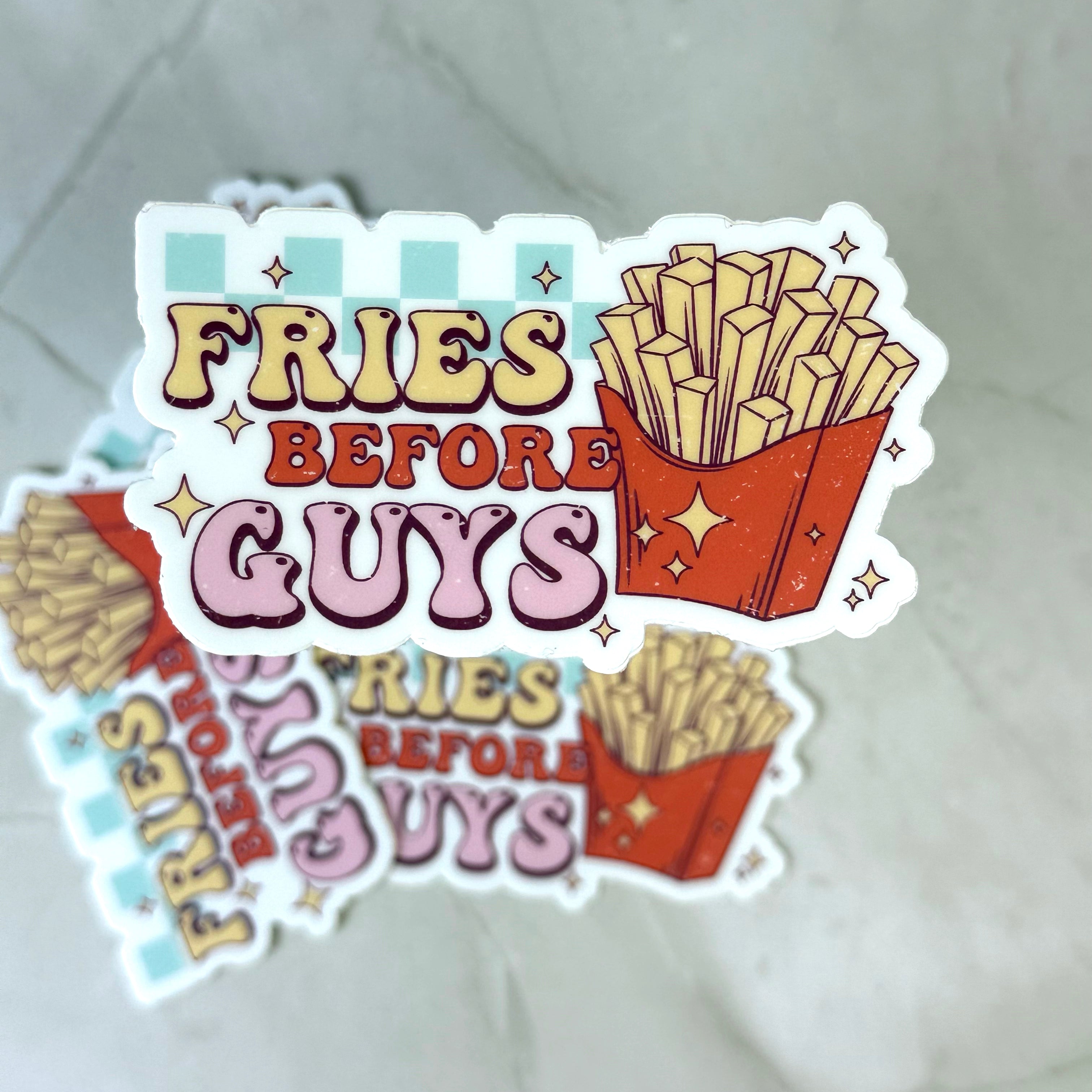 Sticker with 'Fries Before Guys' text and French fries illustration on a textured surface.