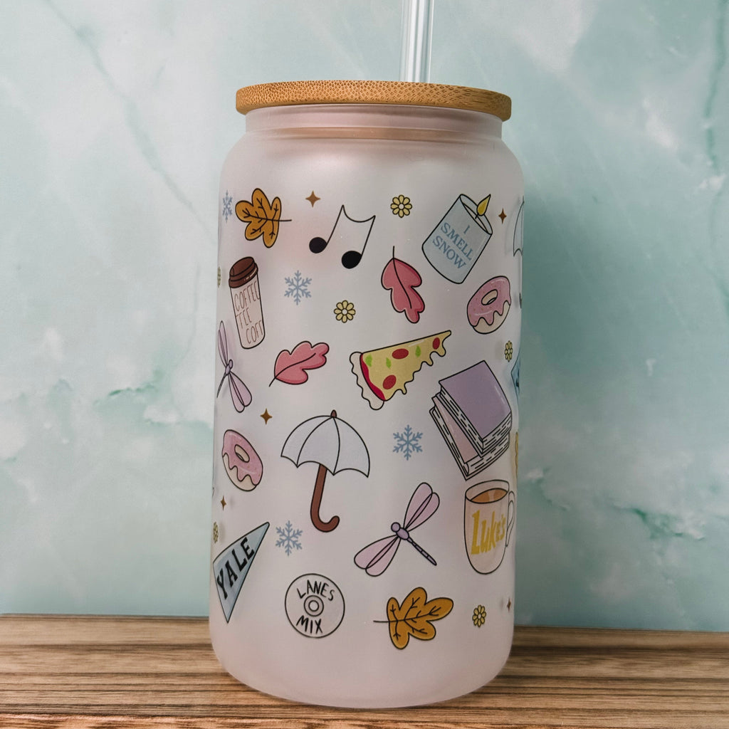 Tumbler with various illustrations on a light blue background