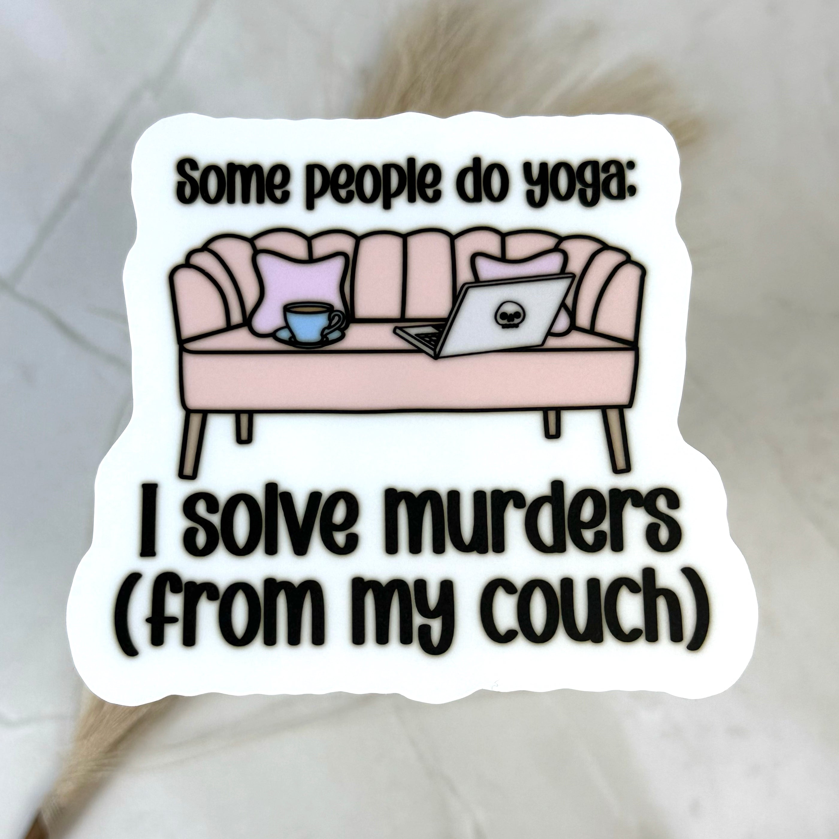Sticker with a couch illustration and text about solving murders from a couch.