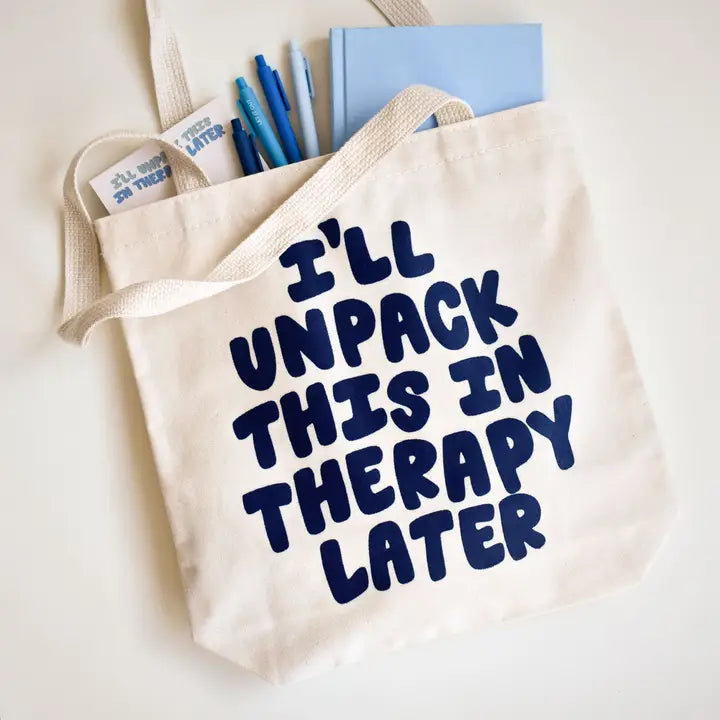 Beige tote bag with 'I'll unpack this in therapy later' text on a light background