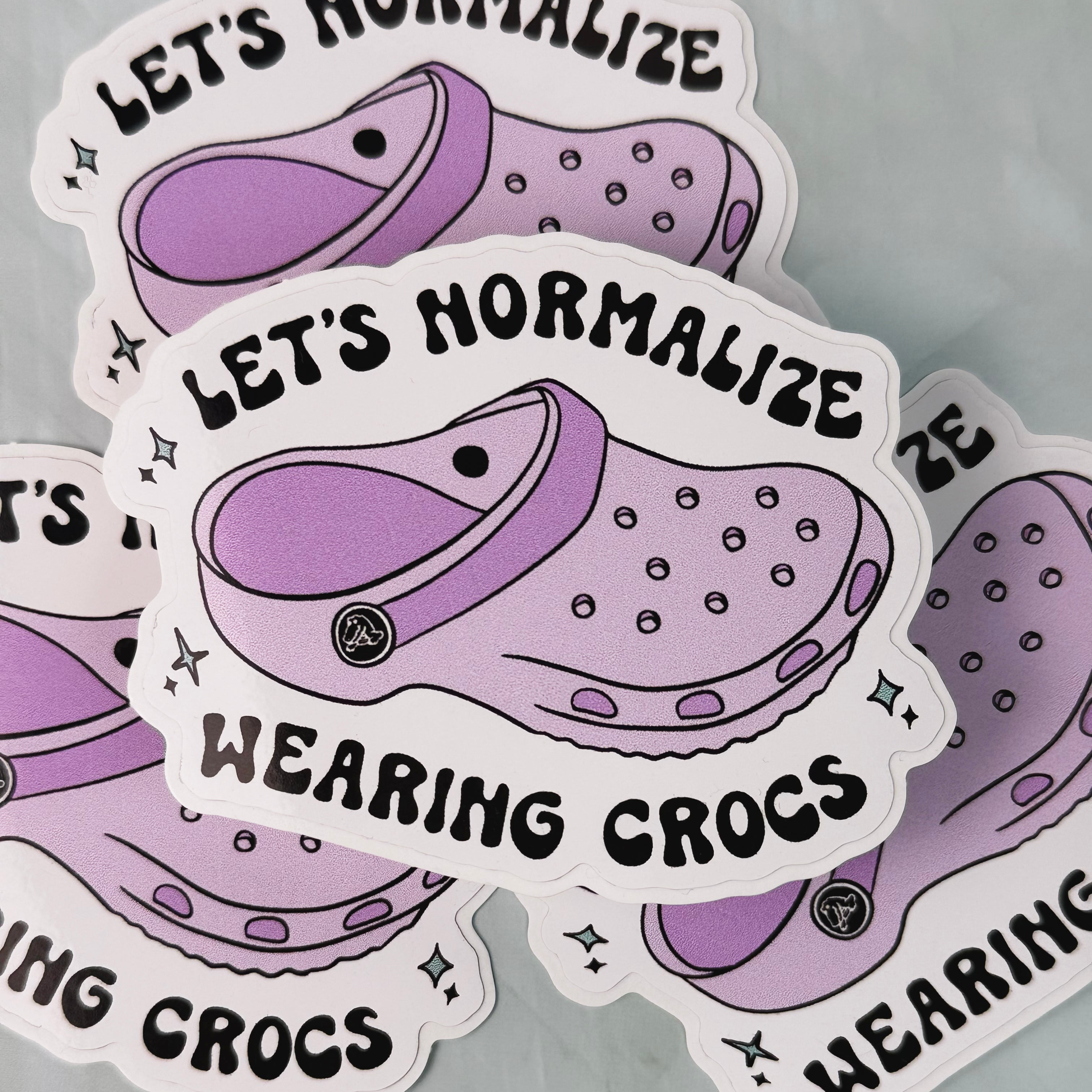 Stickers with purple crocs graphic and text 'Let's Normalize Wearing Crocs' on a gray background