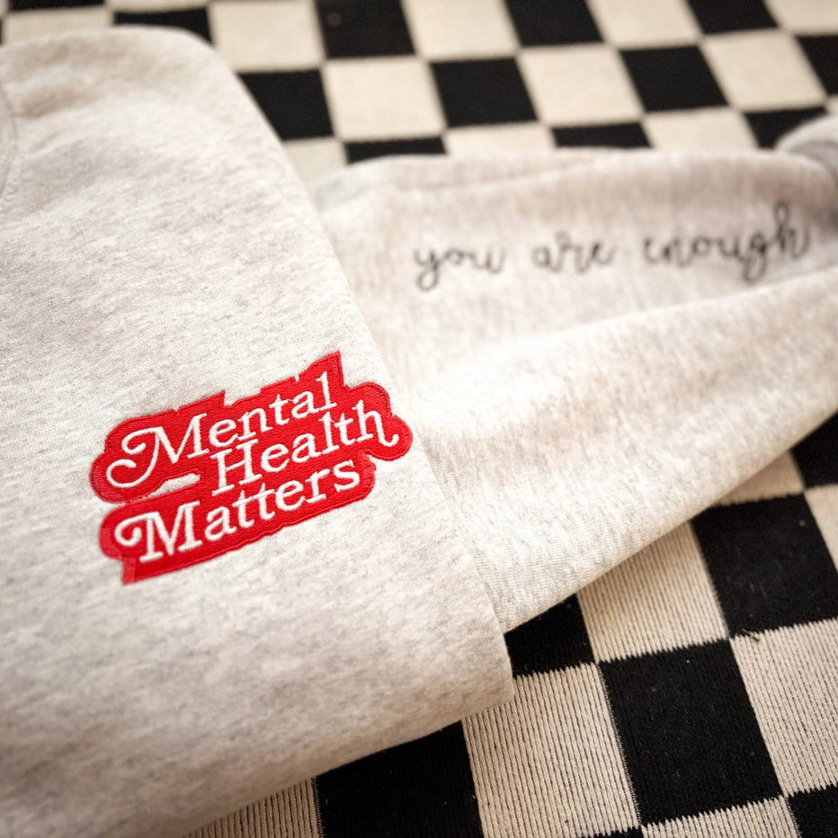 Textile with 'Mental Health Matters' and 'you are enough' on a checkered background