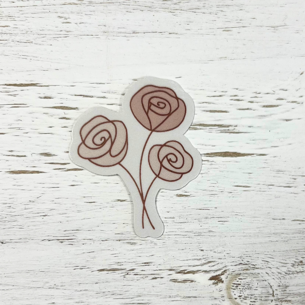 Sticker with three roses on a wooden surface