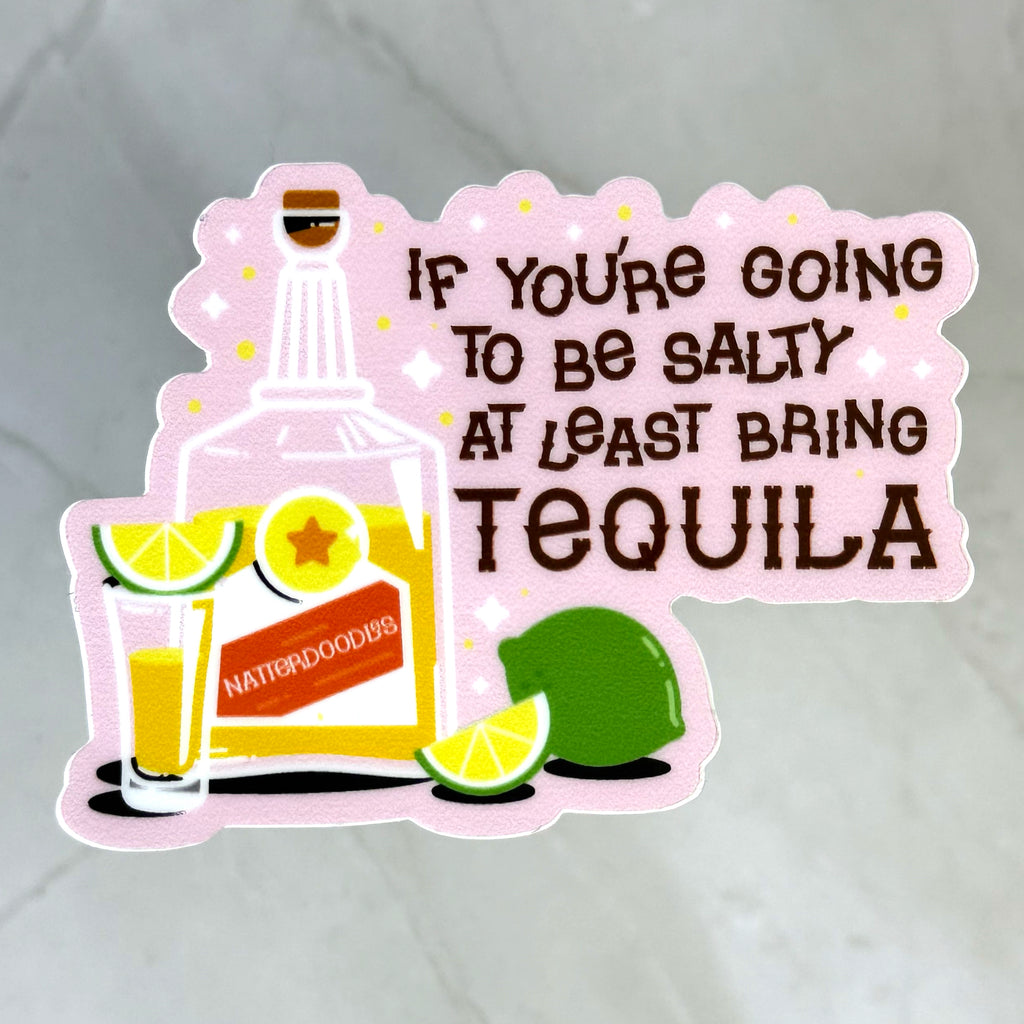 Sticker with tequila bottle, lime, and text 'If you're going to be salty at least bring tequila' on a light gray background.